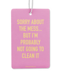Pink air freshener with yellow text on a white background