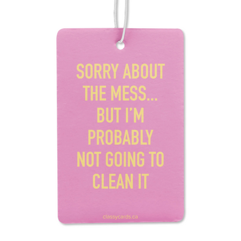 Pink air freshener with yellow text on a white background