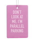 Pink air freshener with humorous text on a white background