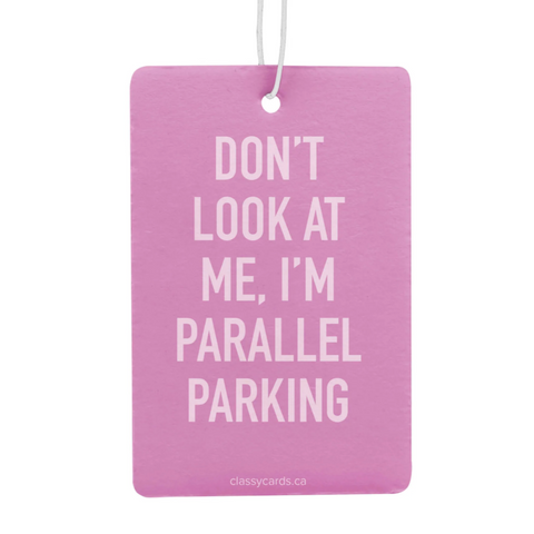 Pink air freshener with humorous text on a white background