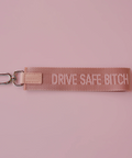 Keychain with 'Drive Safe Bitch' text on a pink background