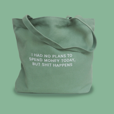 Green tote bag with humorous text on a green background