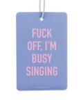 Blue air freshener with pink text 'FUCK OFF, I'M BUSY SINGING' on a white background
