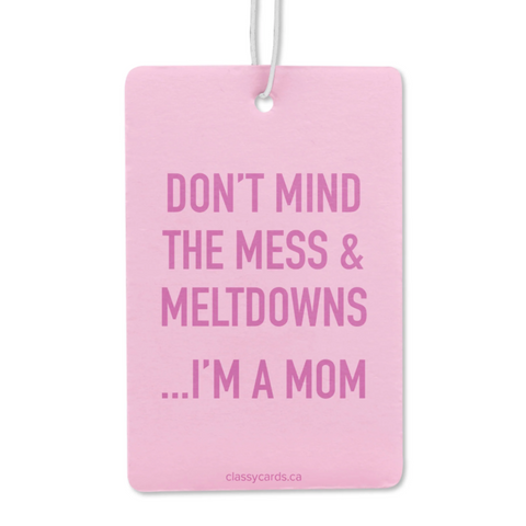 Pink card with humorous text 'Don't mind the mess & meltdowns...I'm a mom' on a white background.