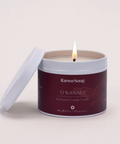 Candle in a branded container on a light gray background