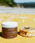 Jar of 'Sacred Tobacco' by RavenSong on a sandy beach with ocean view
