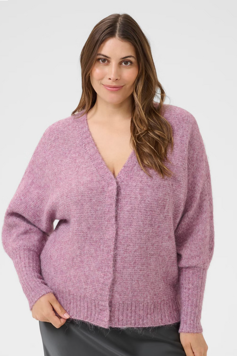 Woman wearing a pink cardigan on a website page