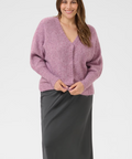 Woman wearing a pink sweater and gray skirt on a product page