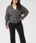 Woman wearing a gray cardigan and black pants on a white background
