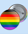 Round button with rainbow flag design on a light blue background