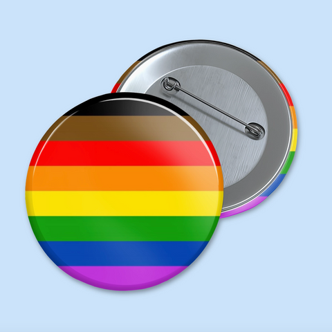 Round button with rainbow flag design on a light blue background