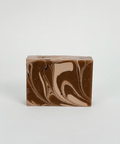Marbled brown and beige soap bar on a light gray background