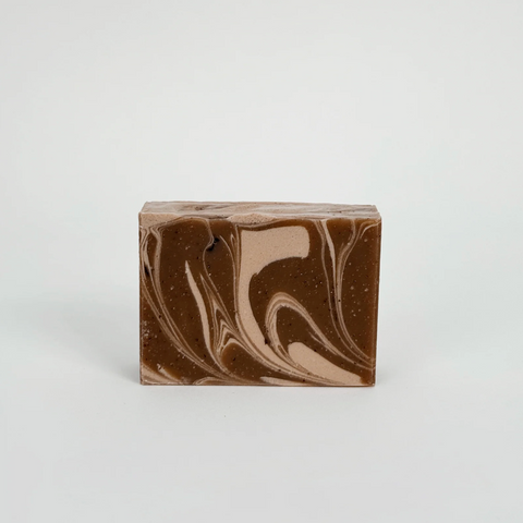 Marbled brown and beige soap bar on a light gray background