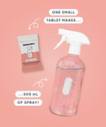 Clear spray bottle with a small tablet and text on a pink background