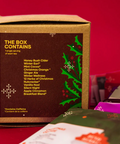 Tea box with holiday-themed packaging on a red background