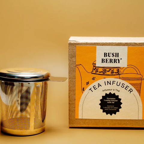 Tea infuser and packaging on a beige background
