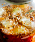 Jar of pickled vegetables with a label on the right side.