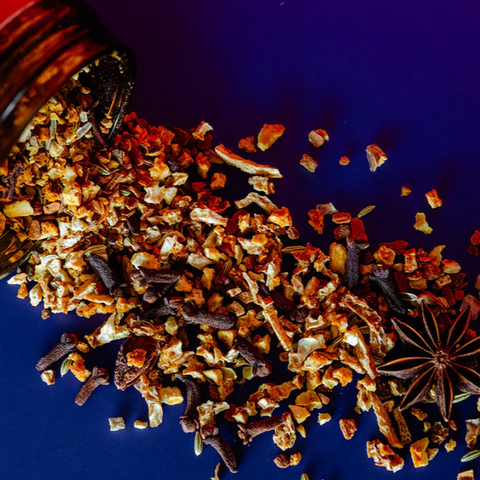 Spice blend with star anise and other ingredients on a blue background