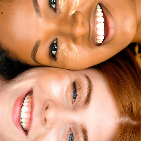Two women with makeup products applied to their faces