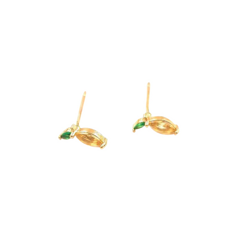 Gold earrings with green gemstones on a white background