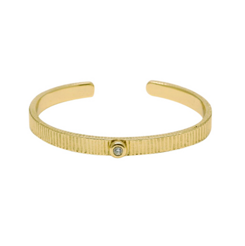 Gold bracelet with a diamond on a white background