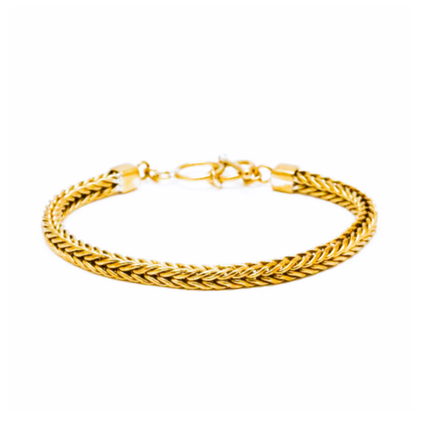 Gold braided bracelet on a white background