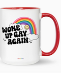 Mug with rainbow and text 'Woke Up Gay Again' on a white background