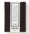 Black notebook with a label on a white background, featuring the brand 'Brass Monkey'.