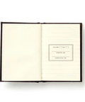 Open notebook with a product description on a white background