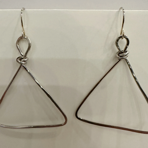 Pair of silver triangle earrings on a white background