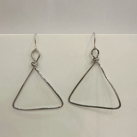 Pair of triangle-shaped earrings on a light gray background