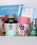 Assorted products including a bottle, tea canister, and bath bomb in front of a 'patchology' box.