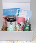 Assorted items including a jar, tea canister, and bath bomb in a box with 'patchology' branding.