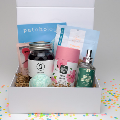 Assorted items including a jar, tea canister, and bath bomb in a box with 'patchology' branding.