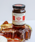 Bottle of bacon whiskey with a decorative glass on a white background