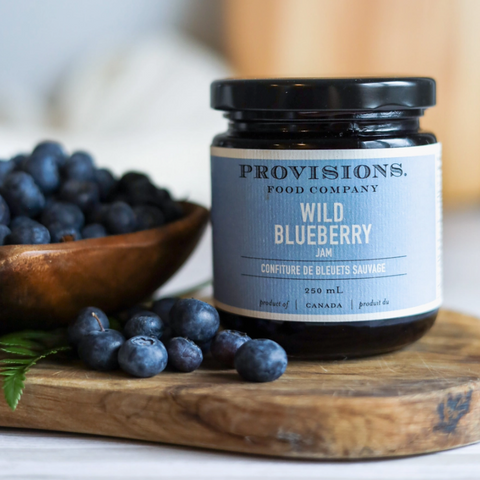 Provisions Wild Blueberry product on a wooden surface with blueberries around