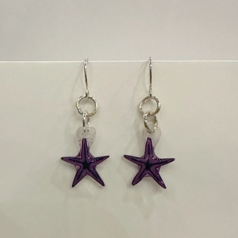 Pair of starfish-shaped earrings on a white background