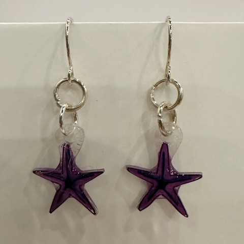 Purple starfish earrings on a beige card with 'Wild Sketches Earrings - TSITP Collection' text.