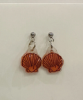 Pair of shell-shaped earrings on a light gray background