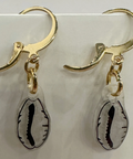 Gold earrings with shell-shaped charms on a light gray background