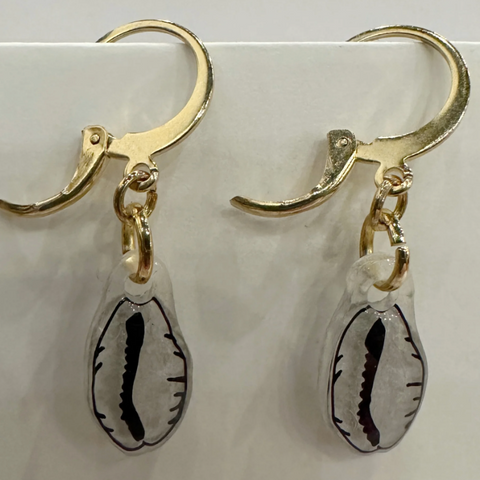 Gold earrings with shell-shaped charms on a light gray background