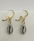 Pair of earrings with gold hooks and shell-shaped charms on a light gray background
