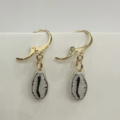 Pair of earrings with gold hooks and shell-shaped charms on a light gray background