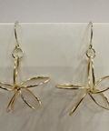 Gold butterfly-shaped earrings on a light gray background