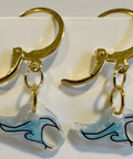 Gold earrings with wave-shaped charms on a white background