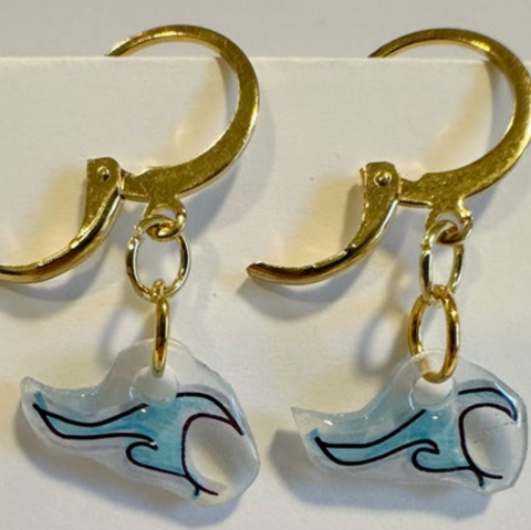 Gold earrings with wave-shaped charms on a white background