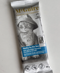 Chocolate bar packaging with a cat illustration and 'McGuire' branding on a gray background