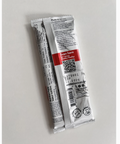 Two small cylindrical packages with labels on a light gray background