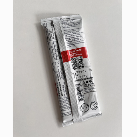 Two small cylindrical packages with labels on a light gray background