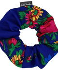 Colorful floral scrunchie with a blue base on a white background